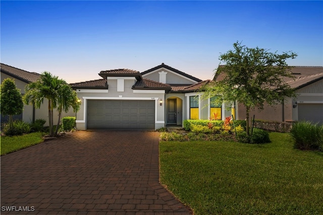 9241 Holden Dr, Fort Myers, FL 33967 - mediterranean / spanish house with a garage and a lawn