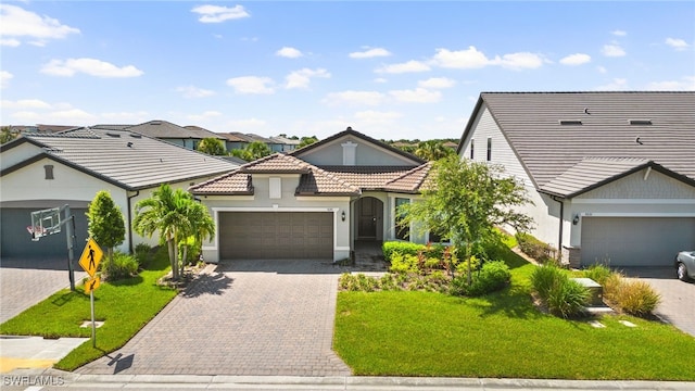 view of front of property with a garage and a front lawn