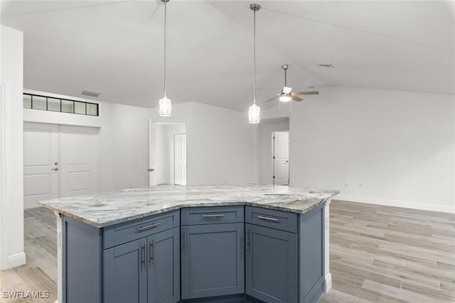 kitchen featuring hanging light fixtures, vaulted ceiling, light hardwood / wood-style floors, and a center island