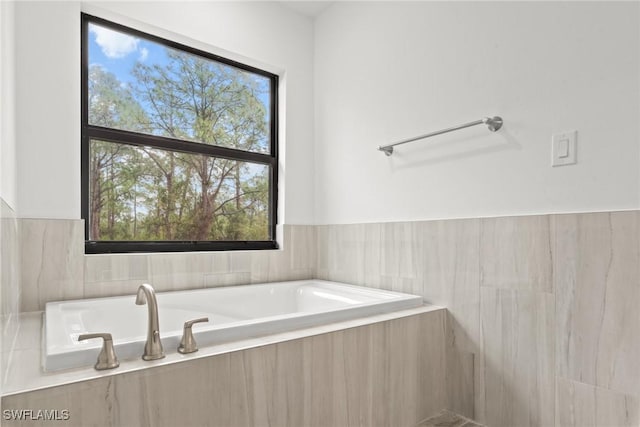 bathroom featuring tiled tub