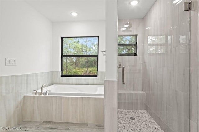 bathroom featuring plus walk in shower