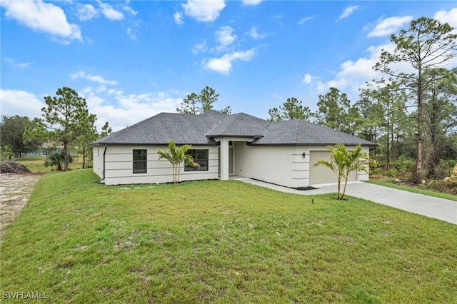 view of front of property featuring a garage and a front lawn