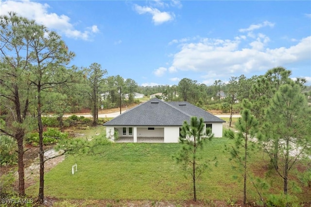 view of side of property with a lawn