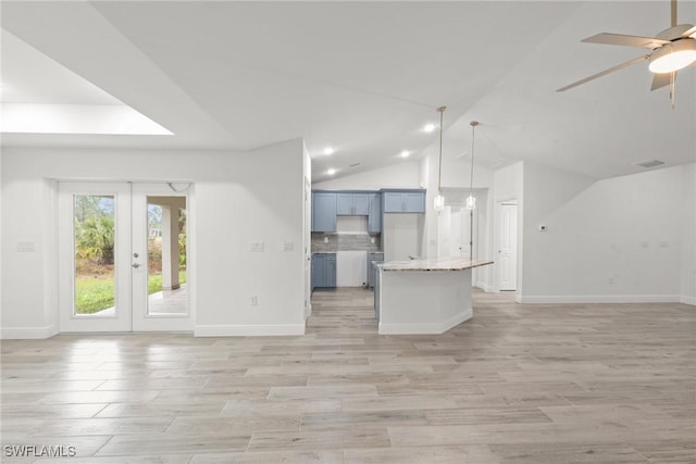 unfurnished living room featuring lofted ceiling, light hardwood / wood-style floors, french doors, and ceiling fan