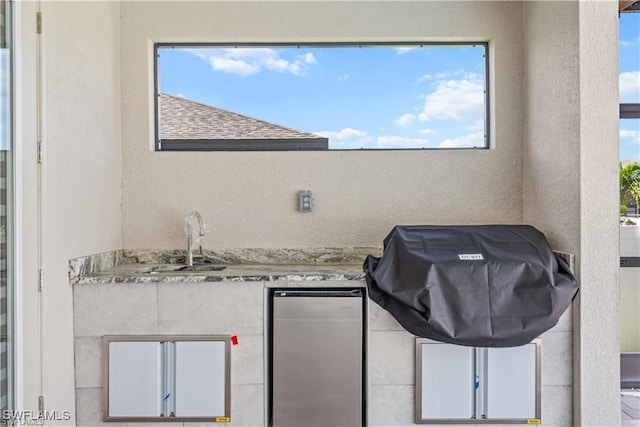 view of patio with sink and a grill