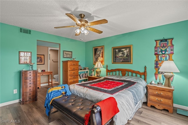 bedroom with ceiling fan, hardwood / wood-style floors, and a textured ceiling