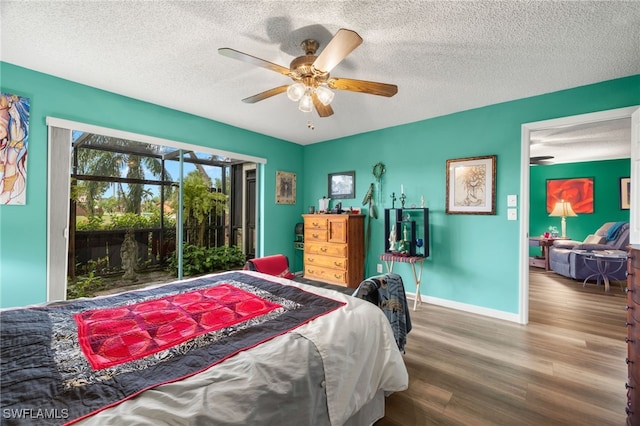 bedroom featuring ceiling fan, hardwood / wood-style floors, and a textured ceiling