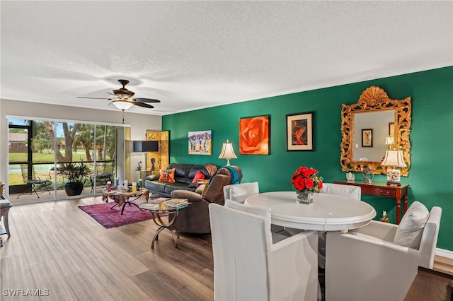 dining room with hardwood / wood-style floors, a textured ceiling, and ceiling fan