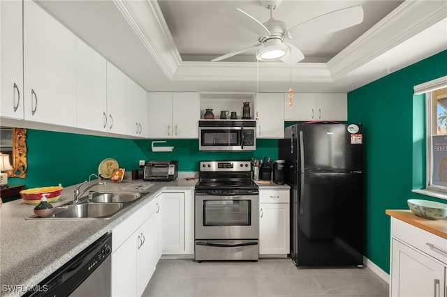 kitchen featuring stainless steel appliances, a raised ceiling, sink, and white cabinets