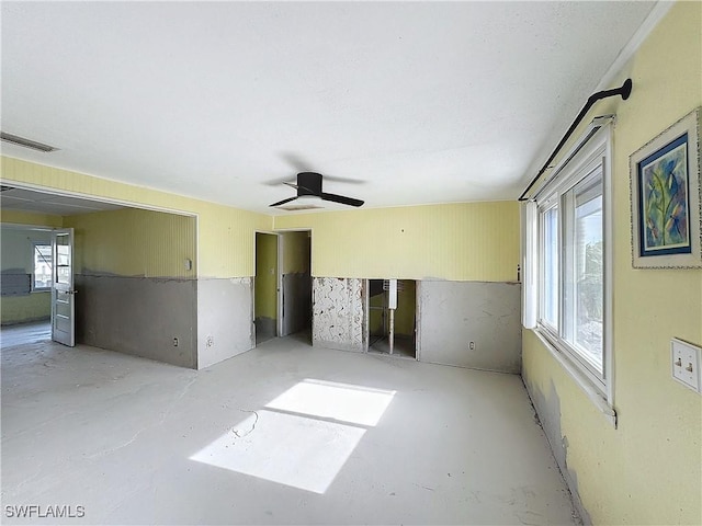 spare room with plenty of natural light, visible vents, and concrete flooring