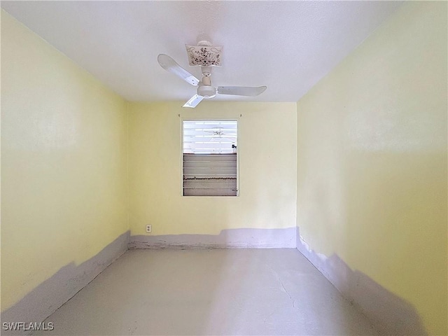 spare room featuring concrete flooring and a ceiling fan