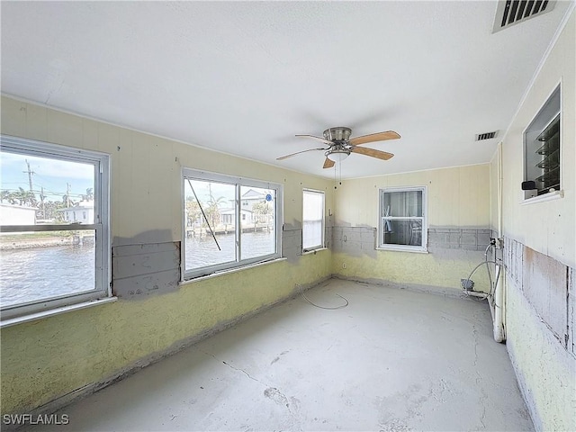 unfurnished sunroom with ceiling fan and visible vents