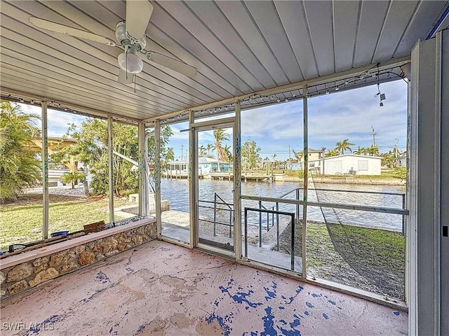 unfurnished sunroom featuring a water view, ceiling fan, and wood ceiling