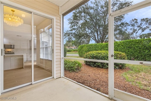 2657 Aft Ave, Naples, FL 34109 - doorway to outside with concrete flooring and wooden walls