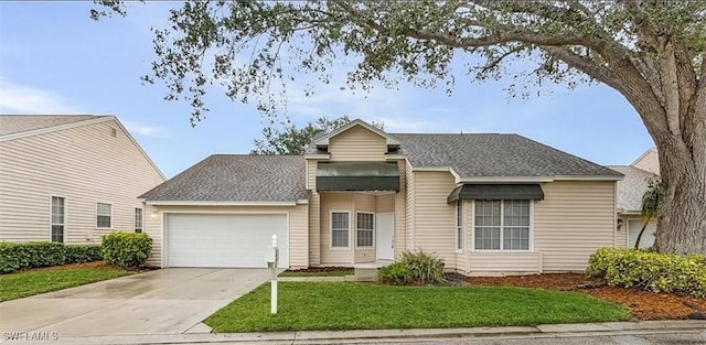 view of front of home with a garage and a front lawn