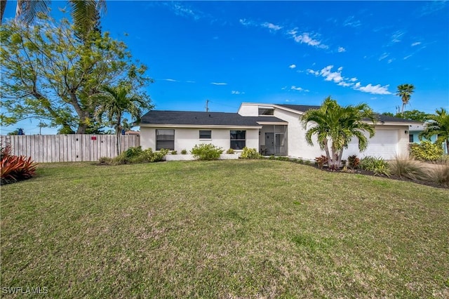 single story home with a garage and a front lawn