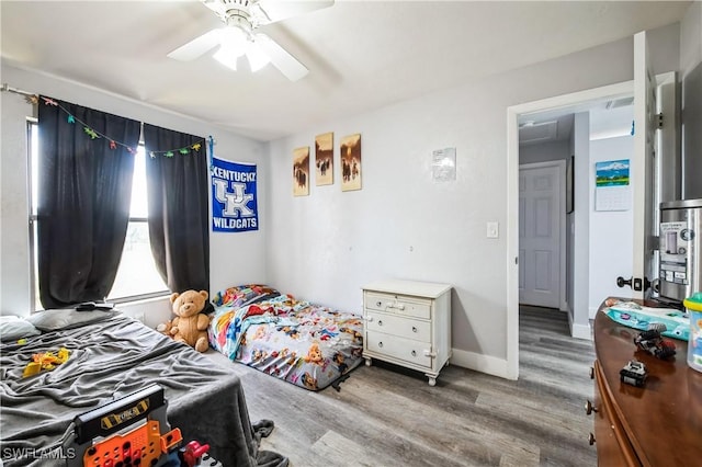 bedroom featuring hardwood / wood-style floors and ceiling fan