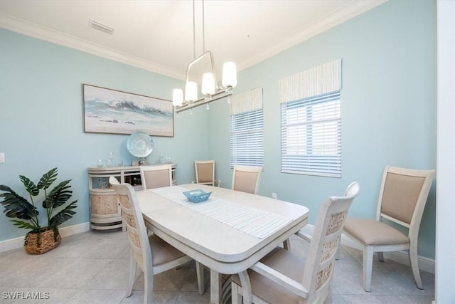 tiled dining space with crown molding and a chandelier