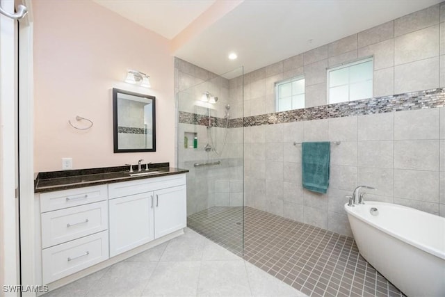 bathroom with tile patterned flooring, vanity, and separate shower and tub