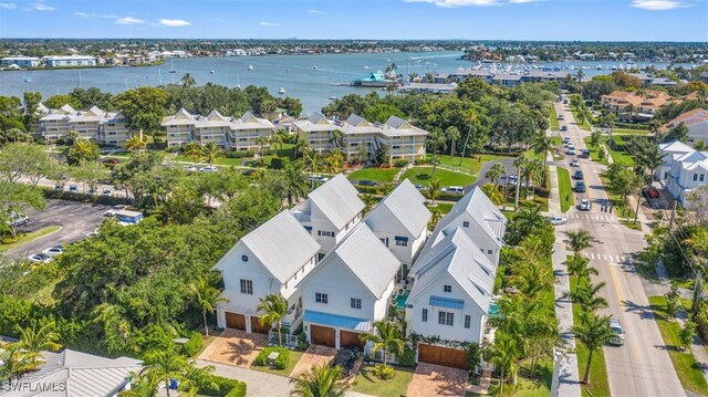 birds eye view of property with a water view and a residential view