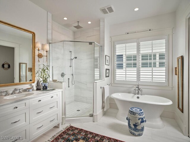 full bathroom featuring a freestanding tub, recessed lighting, vanity, visible vents, and a shower stall