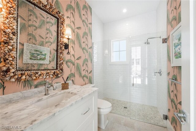 bathroom featuring toilet, a stall shower, recessed lighting, and vanity