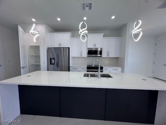 kitchen featuring a large island, sink, pendant lighting, and stainless steel appliances