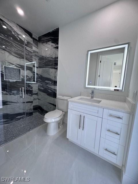 bathroom featuring vanity, an enclosed shower, and toilet