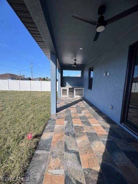 view of patio featuring ceiling fan and an outdoor kitchen