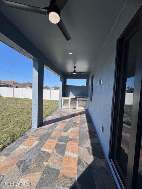 view of patio / terrace featuring ceiling fan