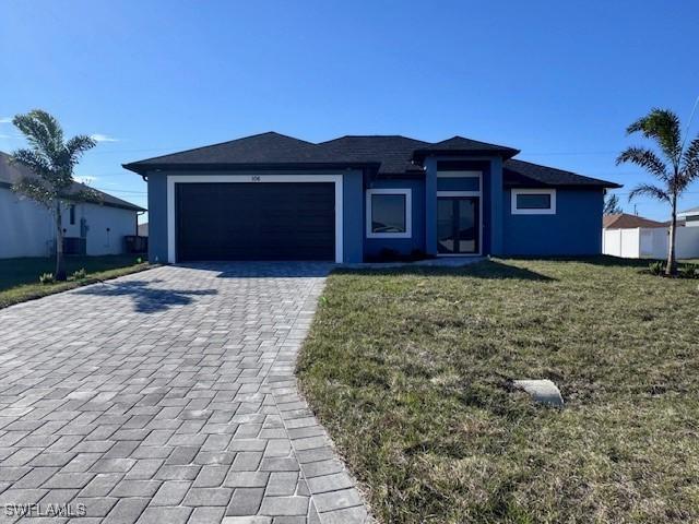 view of front of house with a garage and a front yard