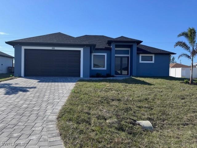 view of front of home featuring a garage and a front lawn