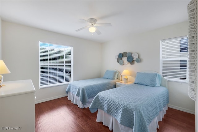 bedroom with ceiling fan and dark hardwood / wood-style floors