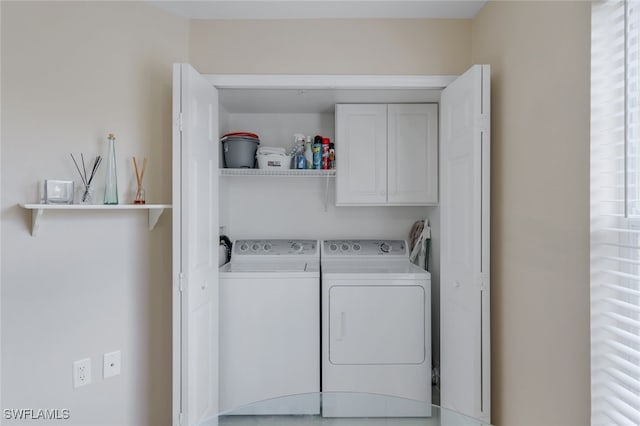 washroom featuring cabinets and washer and dryer