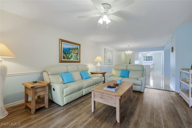 living room with dark hardwood / wood-style floors and ceiling fan