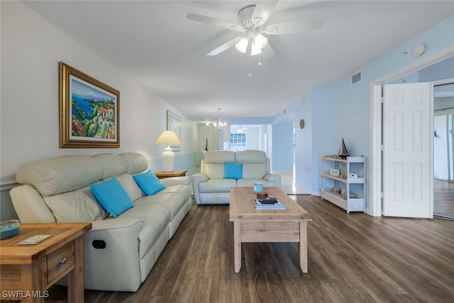 living room with dark hardwood / wood-style floors and ceiling fan with notable chandelier