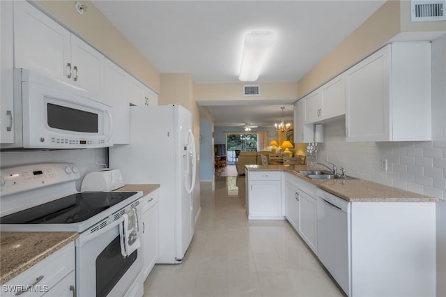 kitchen with white cabinetry, sink, white appliances, and decorative light fixtures