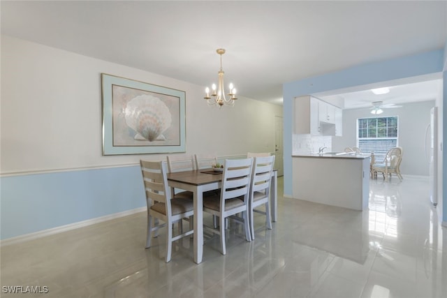 dining room with light tile patterned flooring and a notable chandelier