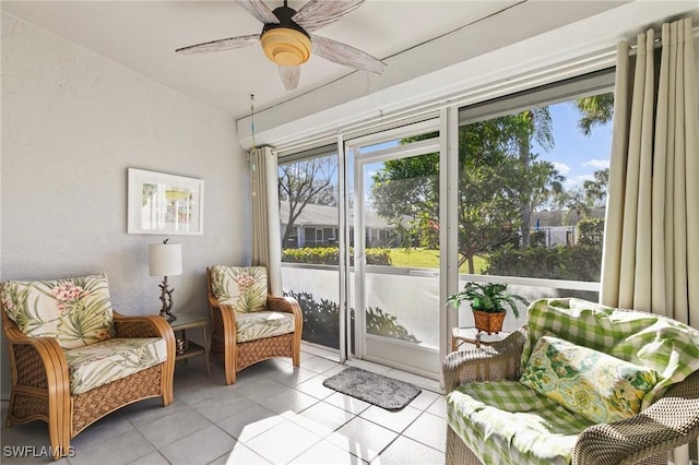 sitting room featuring light tile patterned flooring and ceiling fan