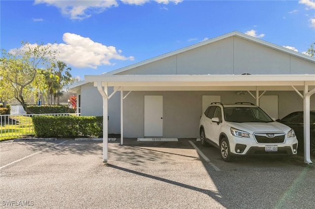 view of parking / parking lot featuring a carport