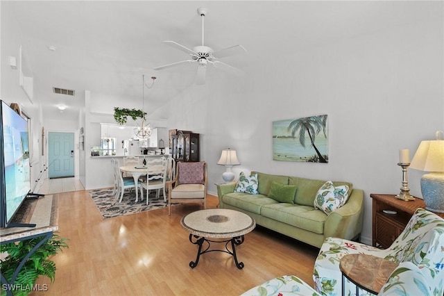 living room with ceiling fan and light wood-type flooring