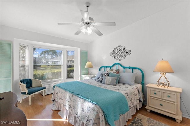 bedroom featuring hardwood / wood-style floors and ceiling fan