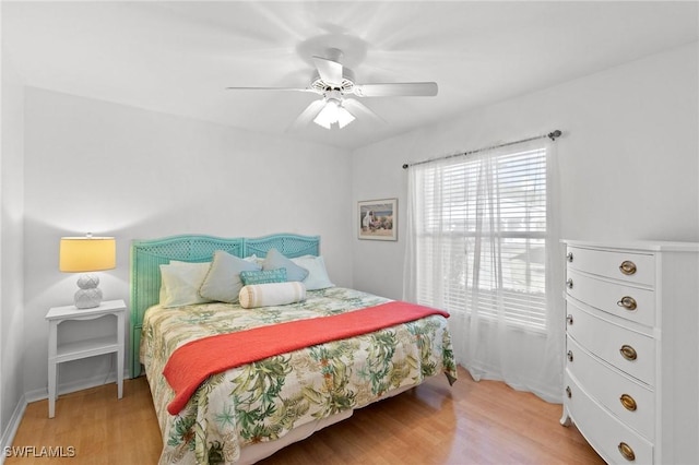 bedroom with light hardwood / wood-style floors and ceiling fan