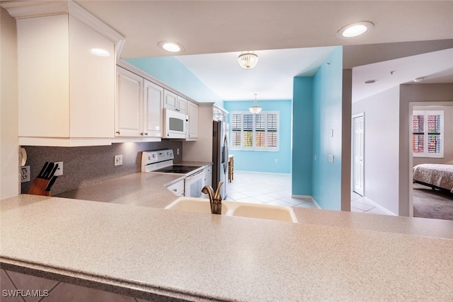 kitchen featuring hanging light fixtures, white appliances, light tile patterned flooring, sink, and white cabinetry