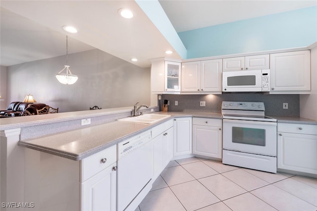 kitchen featuring kitchen peninsula, sink, white appliances, white cabinets, and pendant lighting