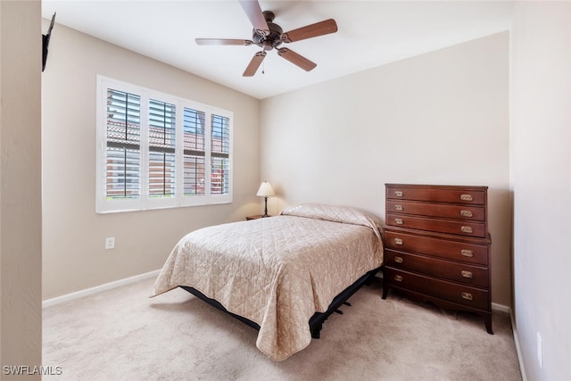 bedroom featuring ceiling fan and light colored carpet