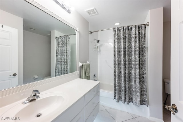 full bathroom featuring toilet, tile patterned flooring, vanity, and shower / tub combo