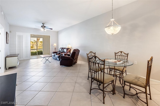 dining room featuring light tile patterned flooring and ceiling fan with notable chandelier