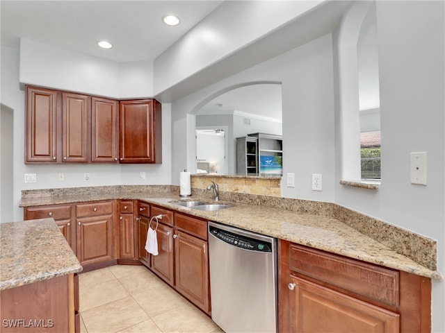 kitchen featuring sink, stainless steel dishwasher, kitchen peninsula, and light stone countertops