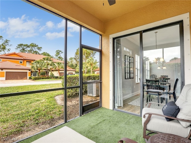 sunroom featuring ceiling fan